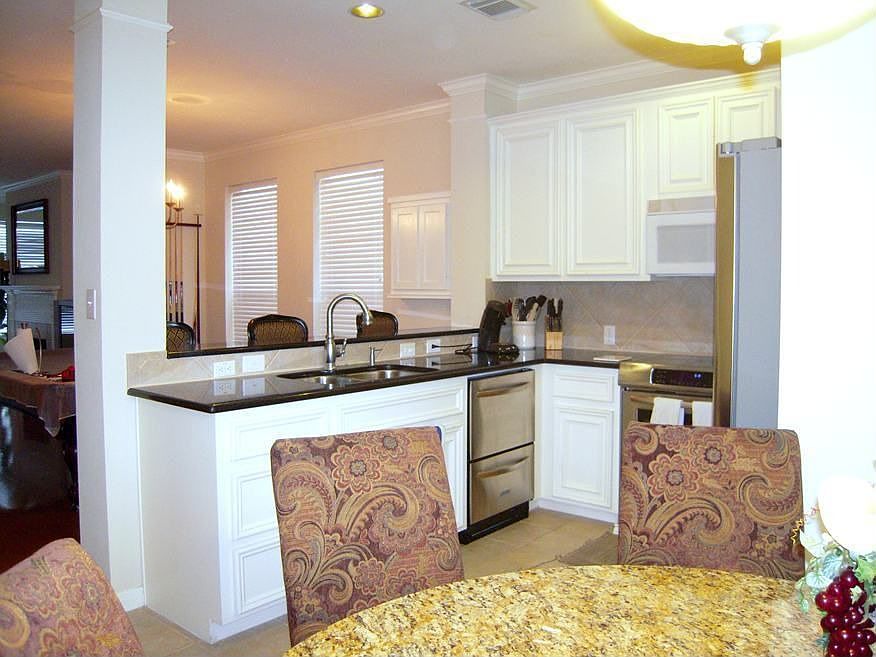 Second view of the kitchen showing a dual drawer stainless dishwasher.