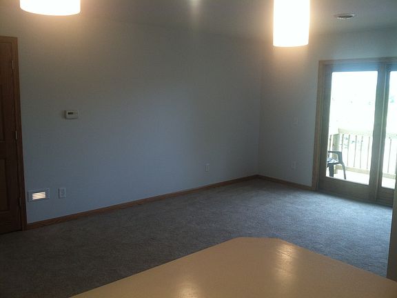 Living room view from kitchen, looking to patio door and balcony