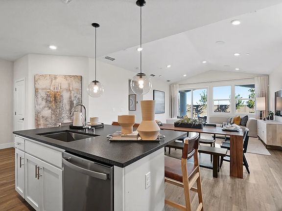 Kitchen with vaulted ceiling and pendant lighting