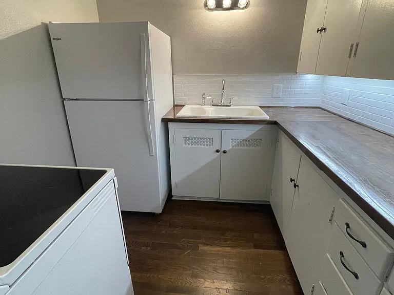 Kitchen - new appliances, subway tile backsplash, and butcher block counters