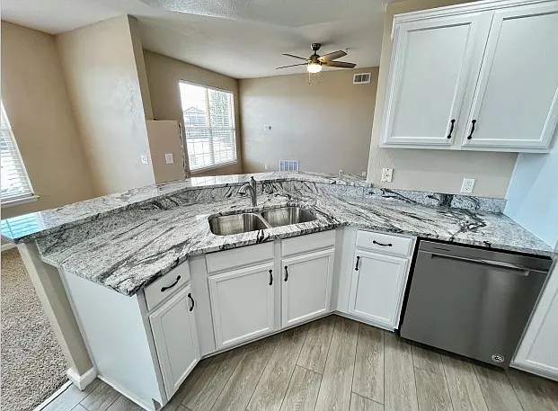 Double kitchen sink and high top bar area. Kitchen includes dishwasher and garbage disposal.