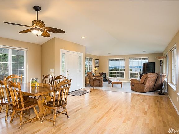 Large open floor plan with living room with a water view, pellet stove for warm cozy days, newly refinished hardwood floors and 