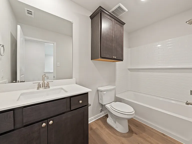 The secondary bathroom has a great vanity space and a shower-tub combo.
