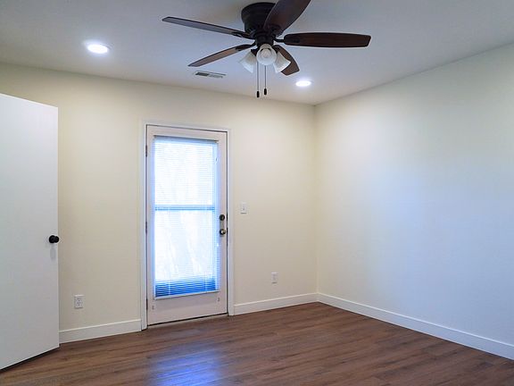 Spacious master bedroom featuring a walk-in closet and a private entry door leading to the outside patio.