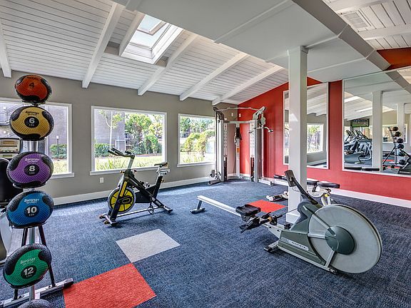 Fitness center with cardio and strength training equipment.