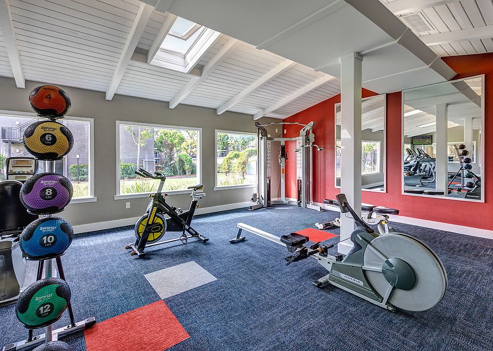 Fitness center with cardio and strength training equipment.