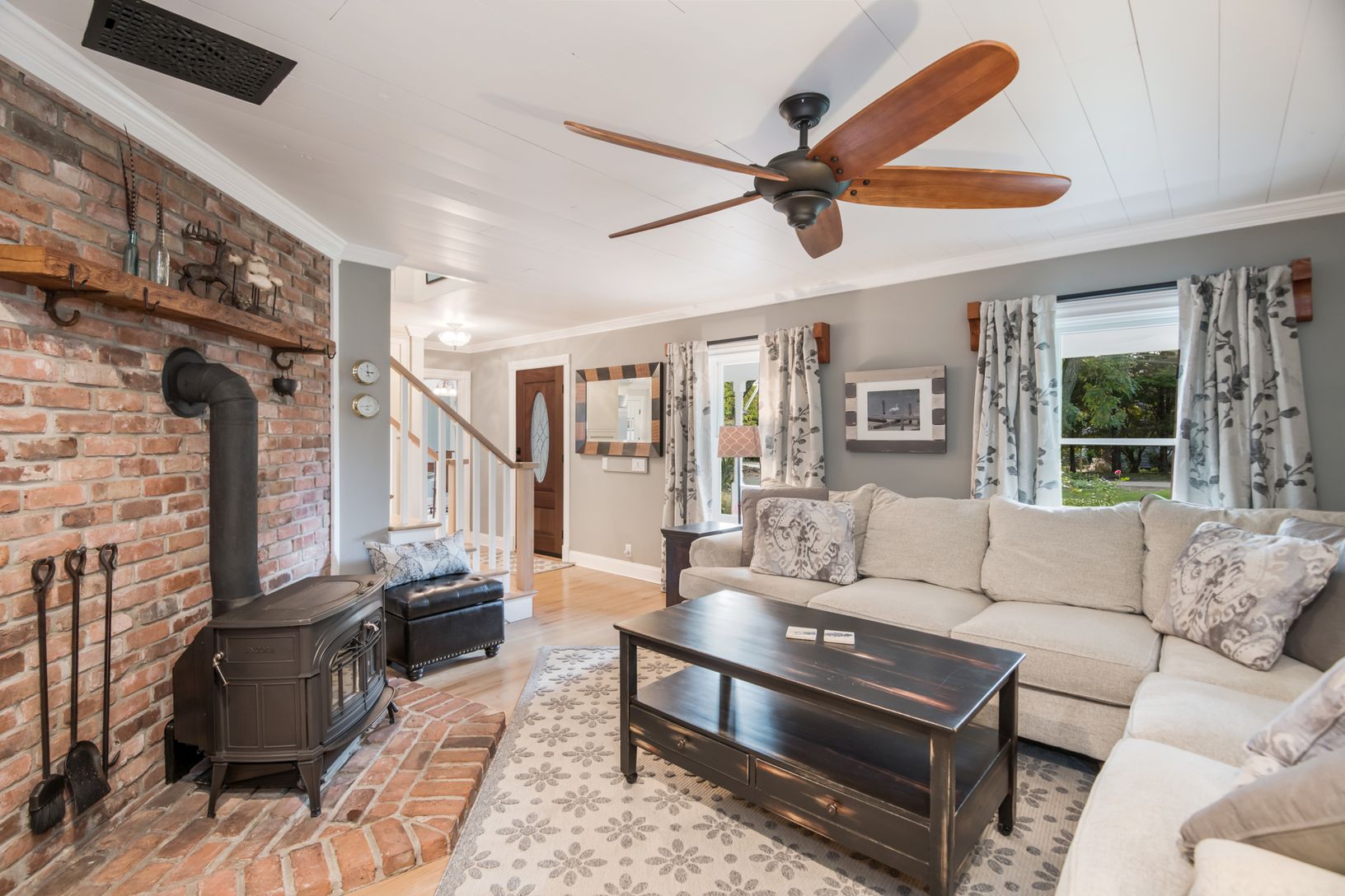  The Living Room Upon Entry. Lush Wrap-Around Couch. Large Flat Screen Television. Wood-Burning Stove