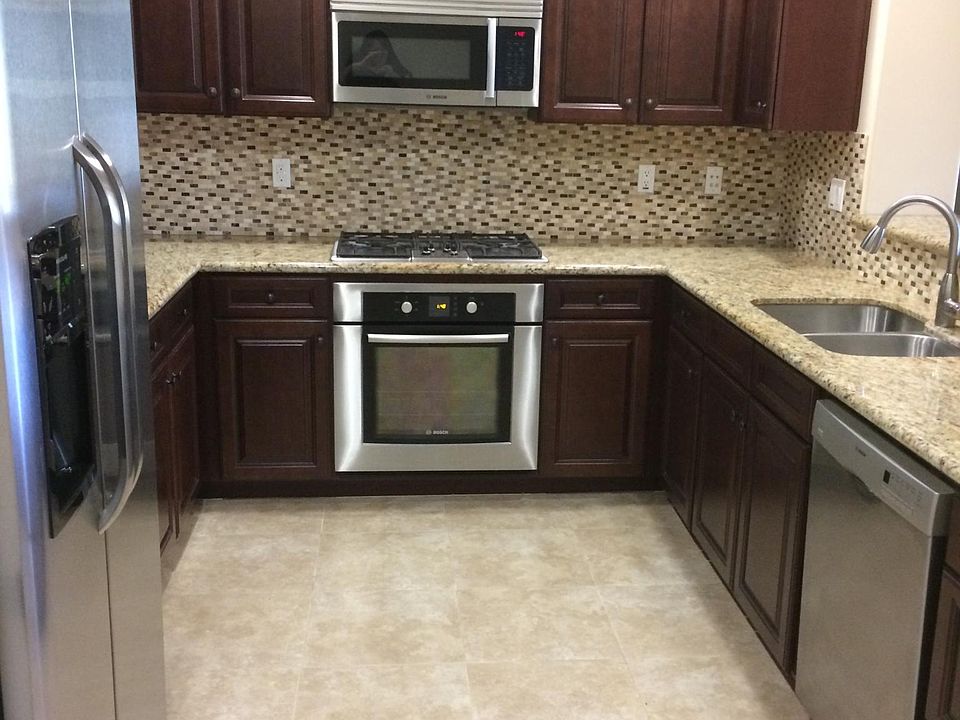 Cherry cabinets, Bosch appliances, open concept with breakfast bar
