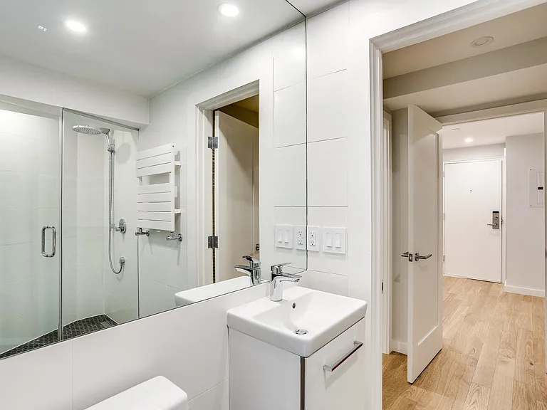 Updated bathroom with chrome appliances and a rain shower
