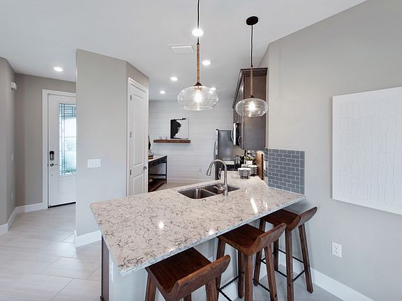 Kitchen with stainless steel appliances and decorative backsplash