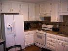 Eat-in kitchen with tile countertops and backsplash