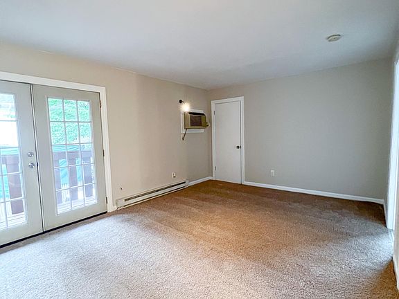 Living room with large french doors that lead to private balcony