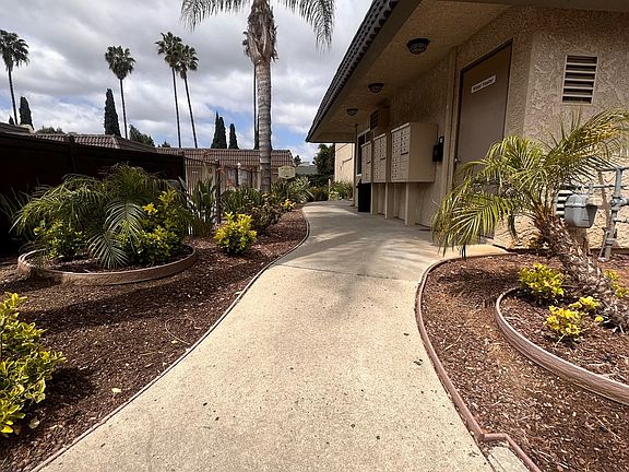 Landscaped walkway behind swimming pool deck at The Meadowlark Apartments.