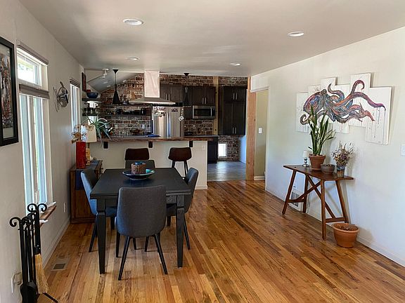 View of dining room and kitchen from entry