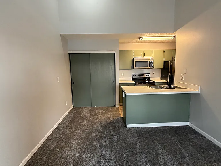 View of living area and kitchen.