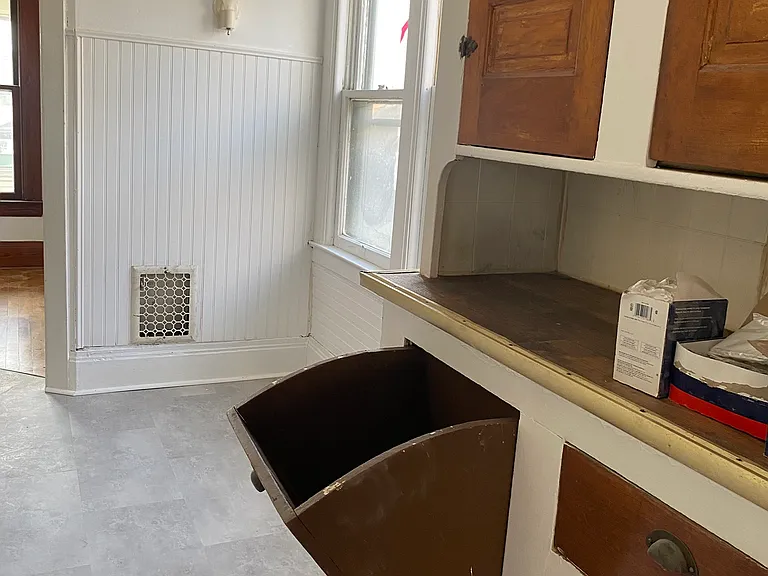 The simple charm of a home built with function and love! Hidden garbage can!