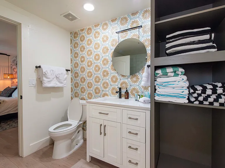 Fourth bathroom has a shower and pool linen storage