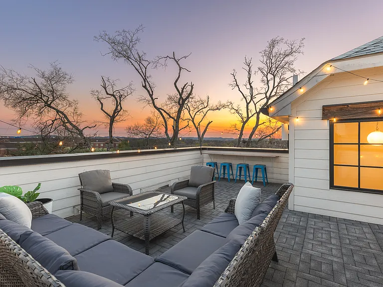 Private rooftop deck with plenty of seating and outdoor lights, allowing you to enjoy your morning cup of coffee or a late night conversation while overlooking the skyline.