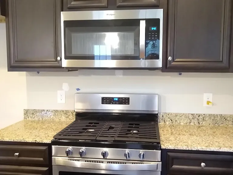 Kitchen with granite countertops & gas top.