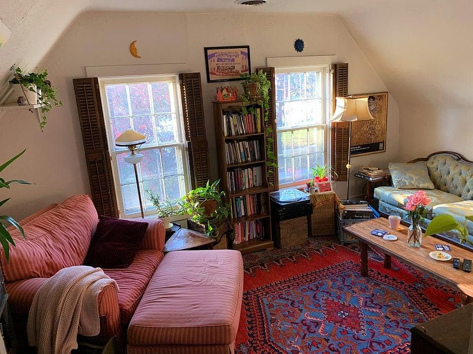Living room windows look out on flowering cherry trees