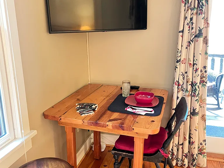 Work desk/dining area below the wall mount smart TV.