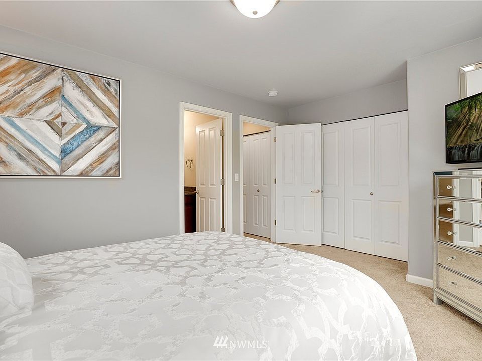 Master bedroom with attached bathroom and a closet with lot of space and in-built organization.