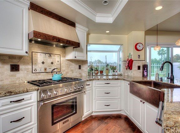 Upgraded Kitchen features stainless appliances and beautiful granite counters and farmer house sink