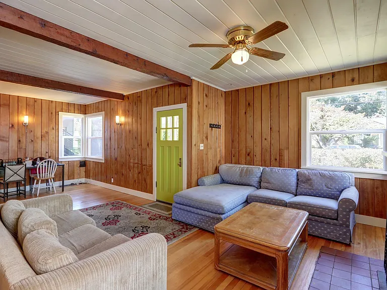 Warm, inviting living room. Real wood paneling and floors!