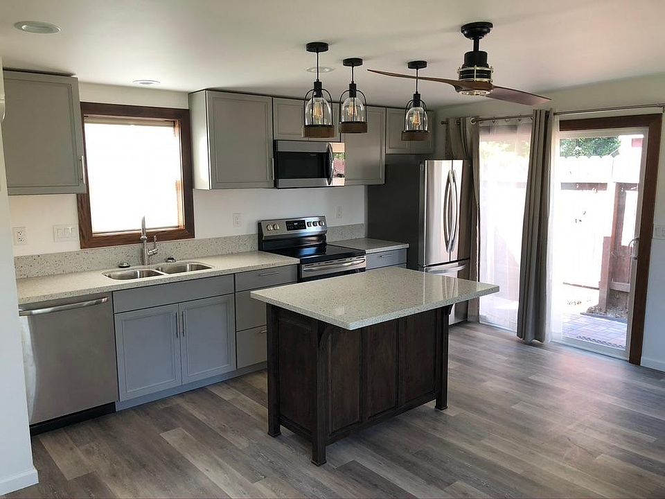 Entry way and kitchen. Kitchen island provides lots of storage for cookware. Edison power under island countertop.