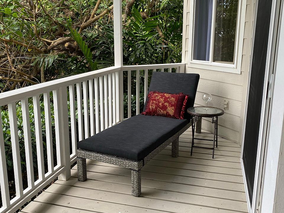Relax on your private deck that overlooks a quiet tropical garden