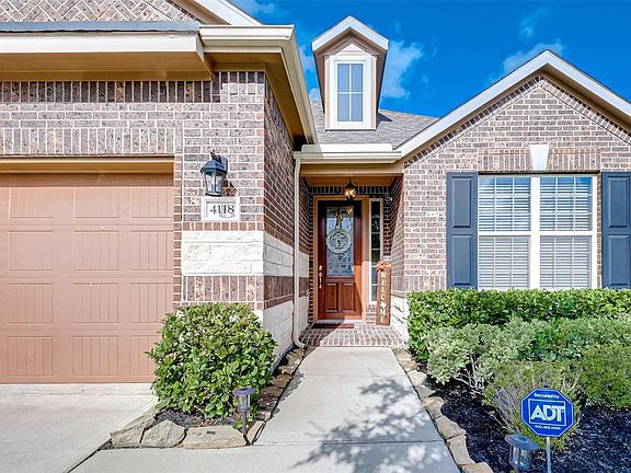 Homeowner installed an automatic sprinkler system in front and back yards. Brick front porch walk.