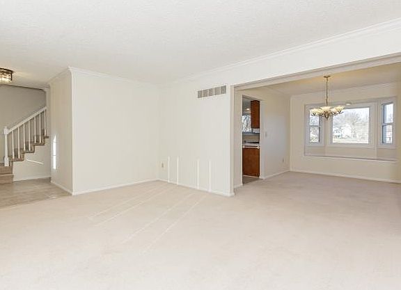 Living room looking into the dining room with bay window & window seat