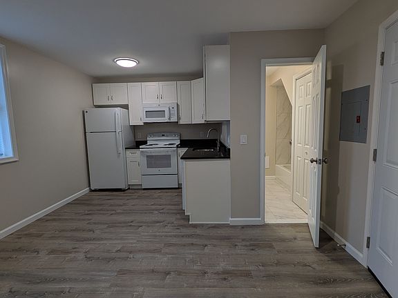 Front door leads to the main living area and kitchen