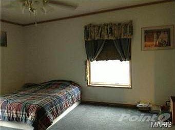 Master bedroom, large windows let in lots of light.