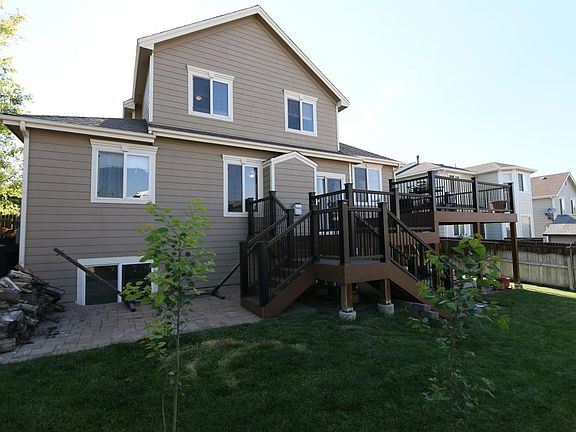 Bi-level TimberTech deck with twin patios.
