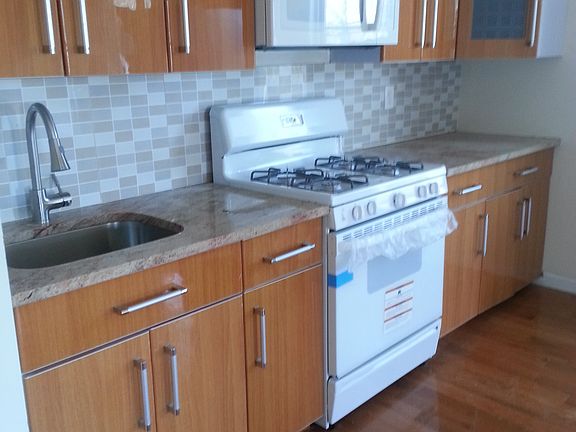 Wonderful Kitchen With New Stove, Cabinets, Fridge and Sink