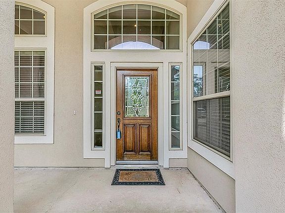 Plenty of windows giving this home a lot of natural light and a beautiful front door with glass inlay.