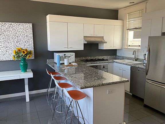 Modern kitchen with dishwasher, Dacor gas range, Thermador oven, full size refrigerator. Many custom down lights.