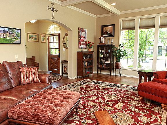 Gleaming wood floors are present in the entry hall and living room.
