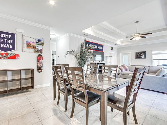 Spacious dining and living rooms, with a double tray ceiling and a number of windows to let in Florida sunshine