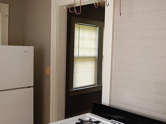 Kitchen stove with copper pot rack