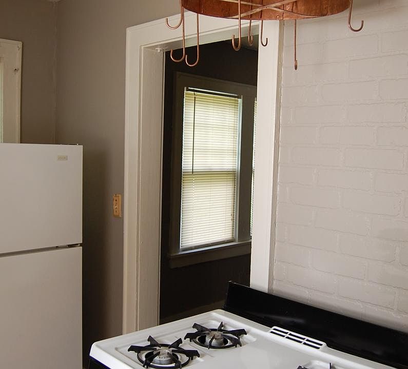 Kitchen stove with copper pot rack