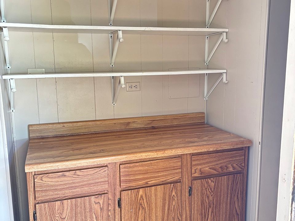 Walk into front door there is shelfs with cabinets.
