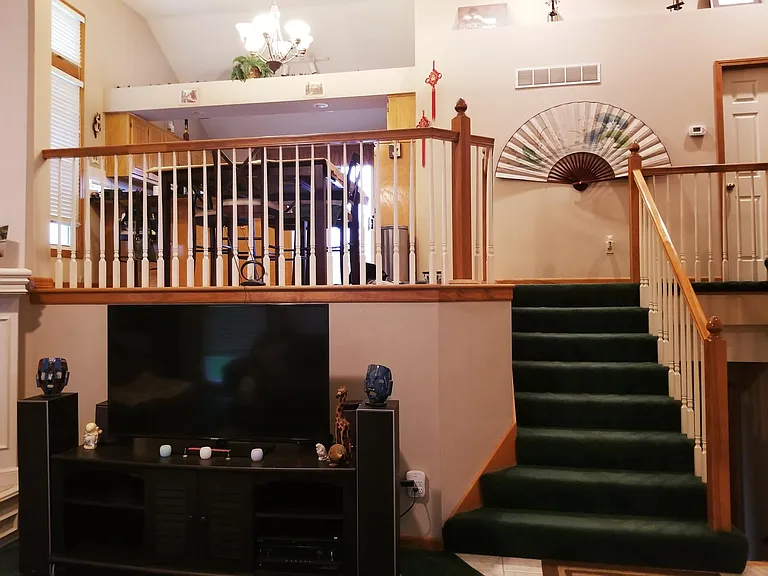 (Old carpet) Living Room shot of the kitchen and beautiful vaulted ceilings.