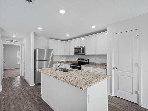 The kitchen is chef-ready with stainless steel appliances