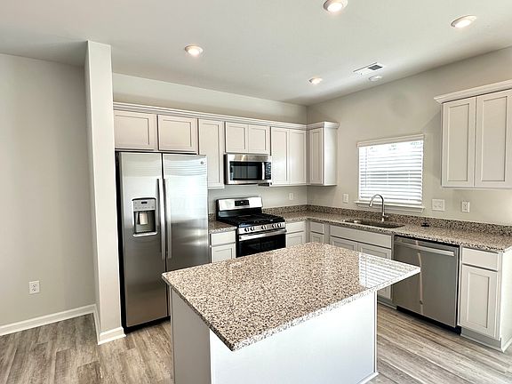 Granit counter tops and plenty of cabinets.