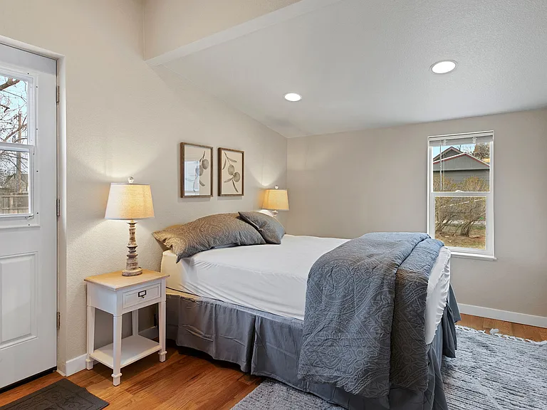 main floor bedroom with Queen bed and walk in closet access to east patio
