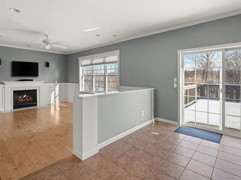Kitchen. Sliding doors to deck. Living room on left. All windows overlook the Winooski River.