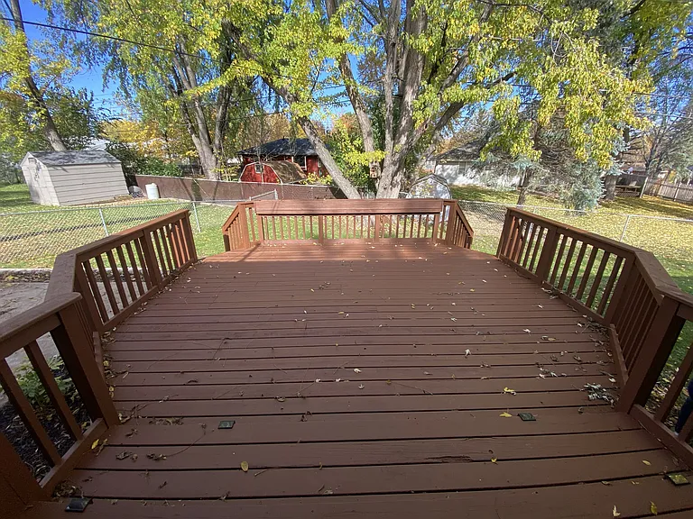 Large deck in fenced in backyard
