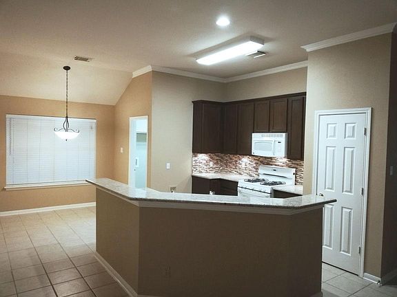 Breakfast area and kitchen. (shows old appliances)